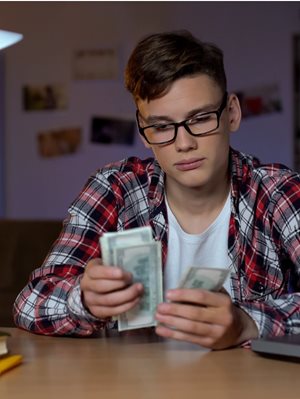 Teenager counting money