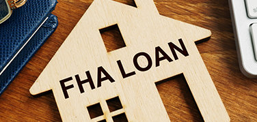 wooden cut out of a house and FHA Loan