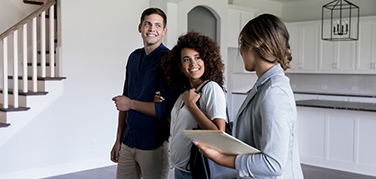 Man and woman talking with their realtor