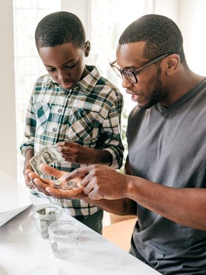 Father and son counting money together