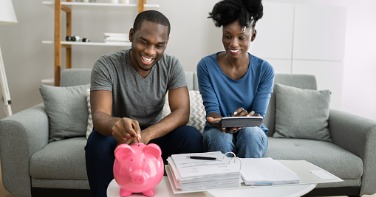 Couple looking at documents on coffee table